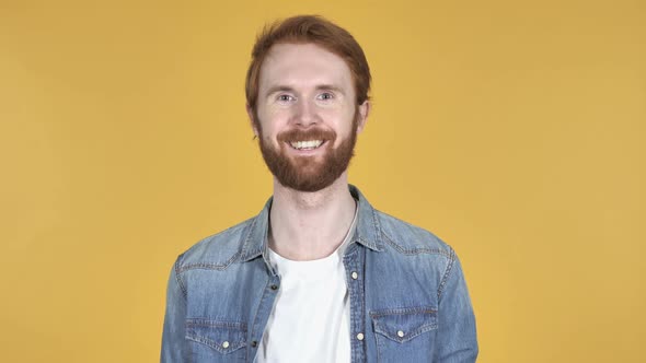Smiling Redhead Man Yellow Background
