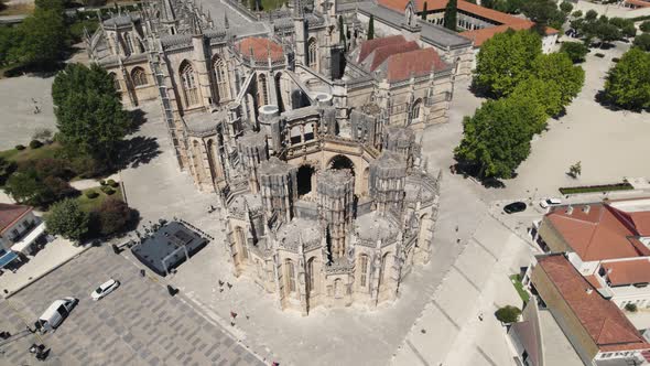 Aerial pan shot around monument of unfinished chapel Capelas Imperfeitas in Batalha, Portugal.