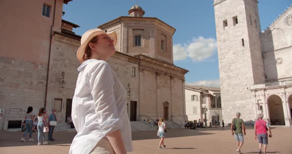 Traveler woman in hat sightseeing antique cathedral in Italy