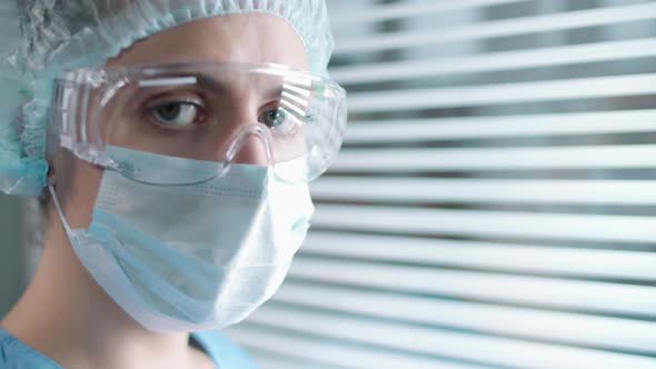 Portrait of Female Nurse in Protective Mask, Glasses and Hat