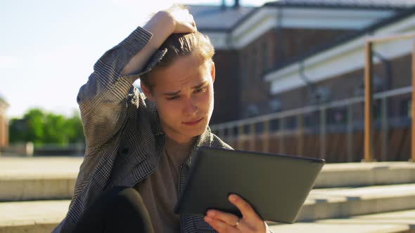 Young Man with Tablet Pc and Drink on Rooftop