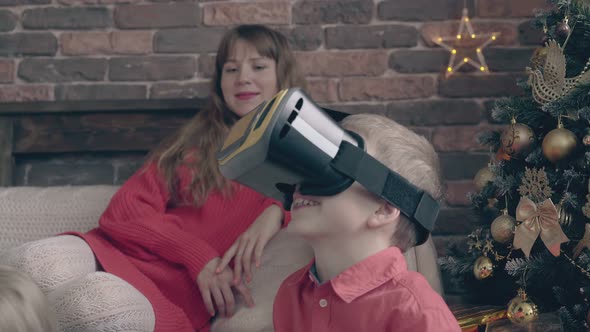 Little Boy with Modern Virtual Reality Glasses on Head Talks