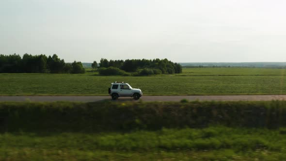 Aerial View of a Car Driving on a Country Road