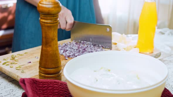 The Chef Cuts Red Onions Into Slices with a Professional Knife