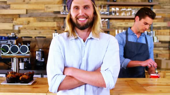 Smiling costumer standing at counter