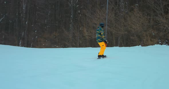 Snowboarder Rides on a Board in the Snow