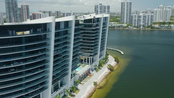 Modern Design Waterfront Glass Building with Miami Cityscape and Bay View