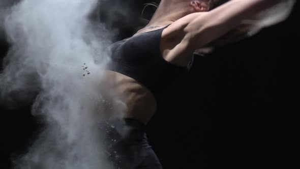 Close-up Virtuoso Dancer Throwing Dust Particles in Air. Slow Motion