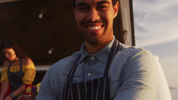 Young man smiling at the camera in food truck