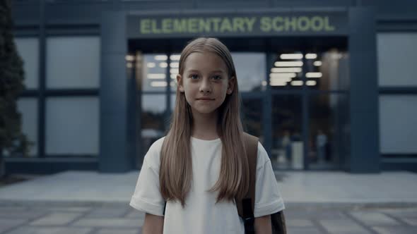 Cute Shy Girl Standing at School Entrance Alone