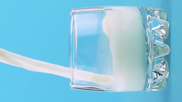 Vertical Video Slow Motion Closeup Shot of Milk Cold Beverage Drink Pooring Into Small Beautiful