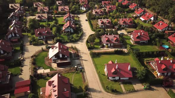 Aerial view from low-flying airplane of residential estates in wealthy neighborhood on a hill. 4k