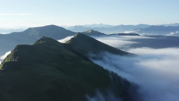 Aerial View Misty Clouds Surrounding the Schwalbenwand Mountaintops in Austria