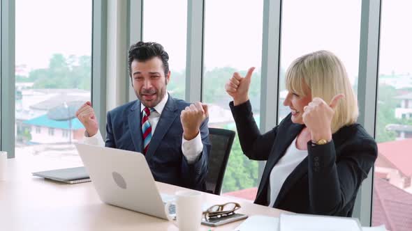 Two Happy Business People Celebrate at Office