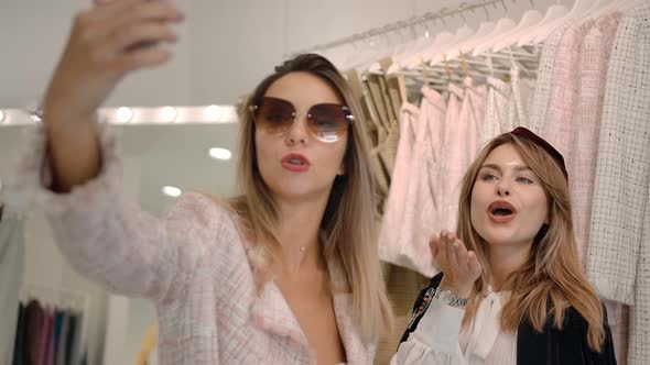 Young Stylish Women Recording Video with Smartphone in Boutique