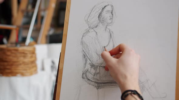 Close-up of Man's Hand Sketching Portrait of Woman During Lesson in Art School