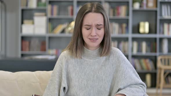 Portrait of Upset Young Woman Crying at Camera