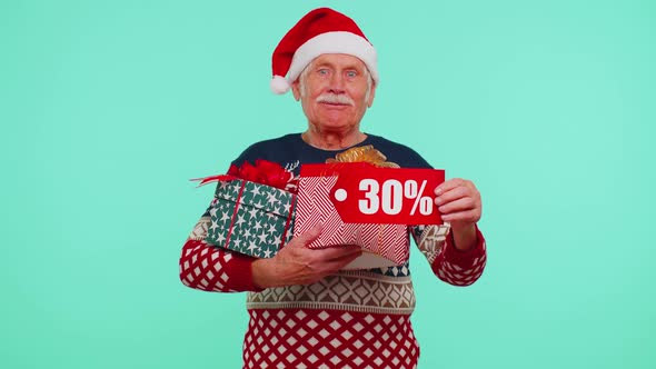 Senior Man in Christmas Sweater Showing Gift Box and 30 Percent Discount Inscriptions Banner Text