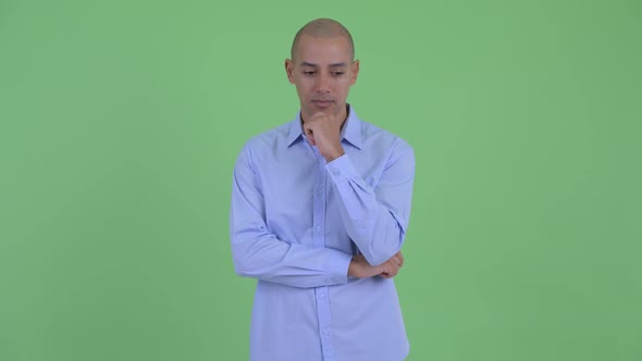 Stressed Bald Multi Ethnic Businessman Thinking and Looking Down