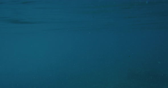 Calm blue ocean with tropical island in background