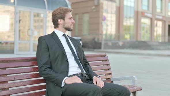 Businessman Standing and Leaving After Sitting on Bench Outdoor