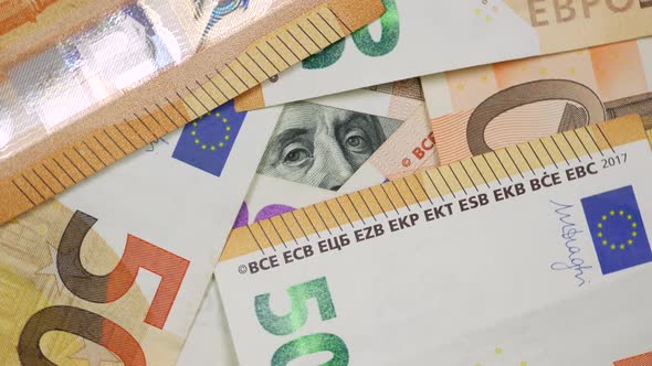 Partly View of 100 Dollars Bill From Under Euro Banknotes