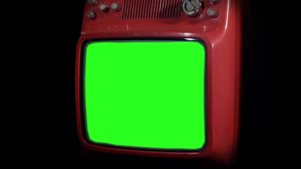 Old Red Television Green Screen Against Black Background. Zoom In.
