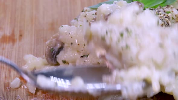 Taking some homemade risotto with a small spoon, macro shot in 4k.