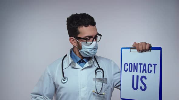 Doctor with Contact Us Sign