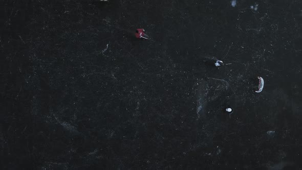 Top View of a Frozen Lake Training Four Children in Hockey Score a Goal Puck in the Gate