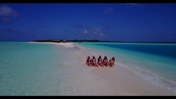 Female models relaxing on relaxing coast beach lifestyle by blue green sea with white sandy backgrou