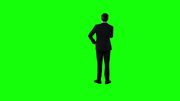 Rear view of a business man waiting with green screen