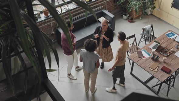 Woman Talking to Colleagues in Office