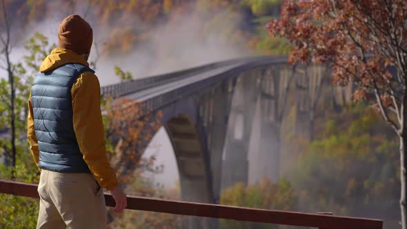 A Man Tourist Visits the Magnificent Djurdjevica Bridge Over the Tara River Canyon in the Northern