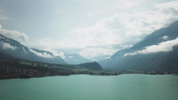 Clouds Almost Touching the Swiss Mountains and a Calm Lake