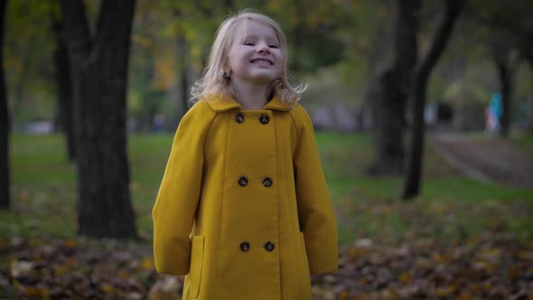 Joyful Childhood, Portrait of a Cute Girl Have Fun in Autumn Park While Relaxing Outdoors