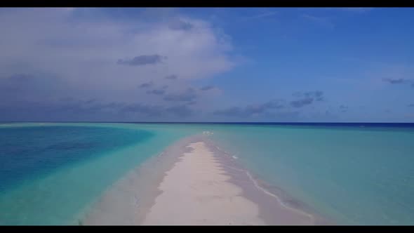 Aerial flying over sky of idyllic coast beach vacation by blue ocean and white sandy background of a