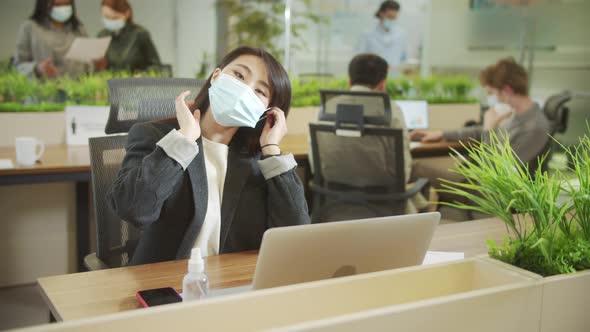 A Beautiful Lady is Putting a Protective Mask on Her Face