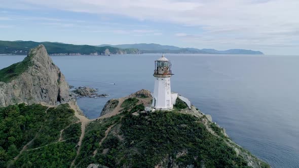 Aerial Orbital View of an Old Lighthouse on the Cliff on Pacific Coast