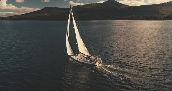 Yacht Cruise in Sunlight Reflection at Open Sea Bay Aerial alt