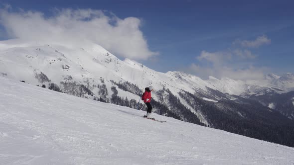 Woman Skier Skiing Down On Ski Slopes On Skis On Sunny Winter Day