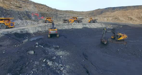 Many Dump Trucks and Excavators Mine Coal