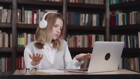 Teen Girl School Wear Headphones Learn Watching Online Webinar Webcast Class Looking at Laptop