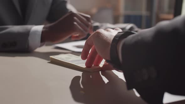 Close Up of Black Entrepreneur Receiving Money from Business Partner