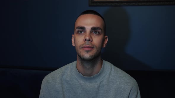 Interest, Passion, Enthusiasm Concept, Man Alone in Room Watches TV in Evening and Eats Popcorn