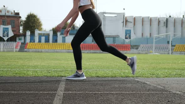 Slim Fit Asian Runner in Sportswear Starts Running From Block on Stadium Track