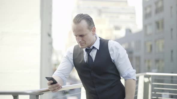 Businessman reading news using smart phone