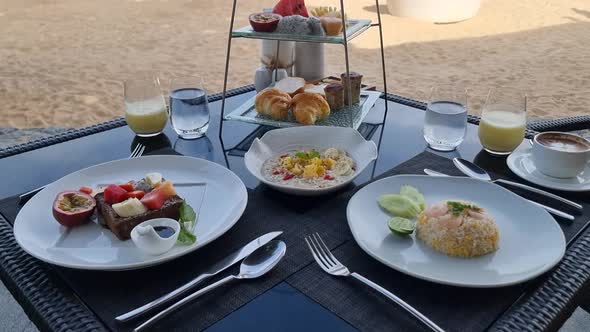 Breakfast on the Beach in Thailand a Luxury Breakfast Table with Food and Beautiful Tropical Sea