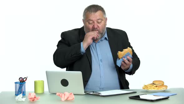 Excessive Office Worker Having an Unhealthy Snack