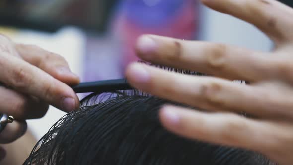 Barber Does New Haircut To Client with Black Hair in Salon